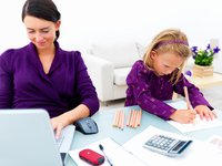mom working with daughter at computer