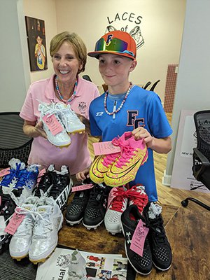 Jeanne Nealon, founder of Laces of Love, receives a donation from Michael Roberts.jpg