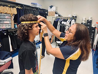 a band member getting measured for his uniform.jpg