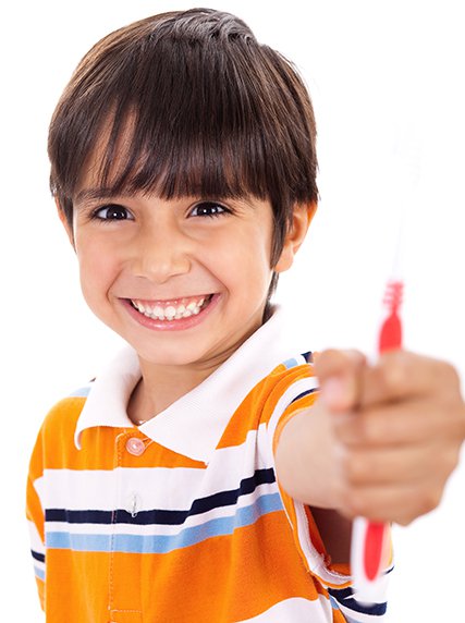 boy holding toothbrush