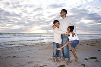 father with children on beach