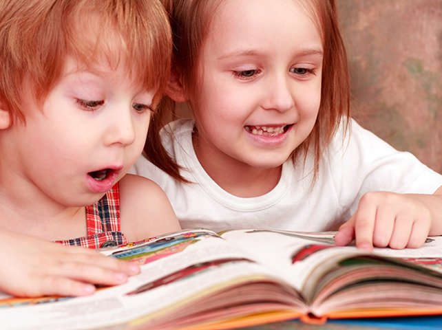 2 girls reading from book