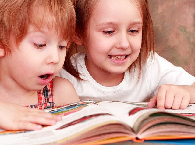 2 girls reading from book surprised.jpg