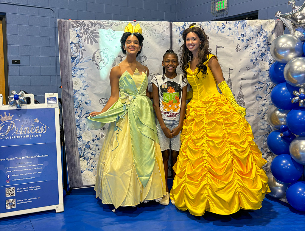 Kid taking a selfie with two princesses at the Back to School Expo
